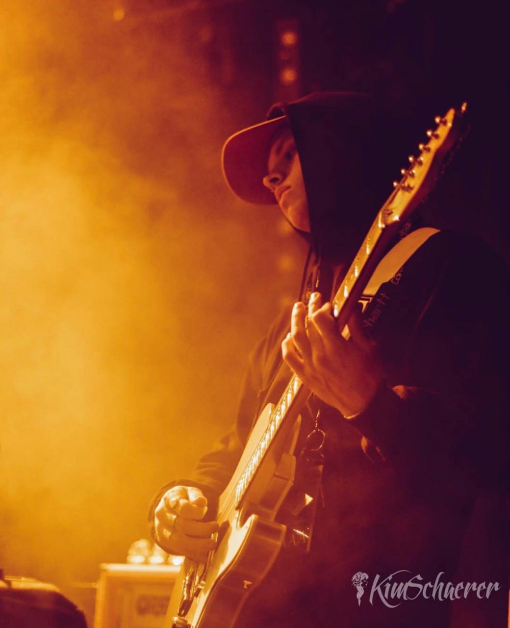 Seb Sanders performing with guitar on stage